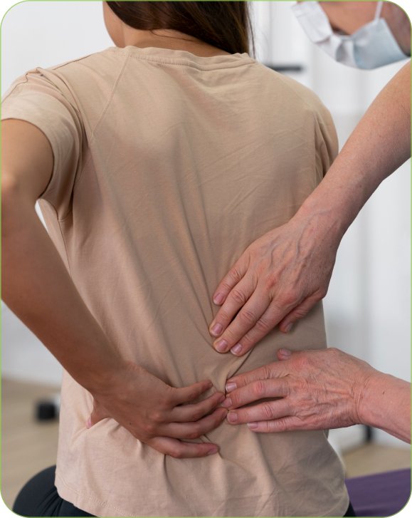 Chiropractor examining a patient’s lower back