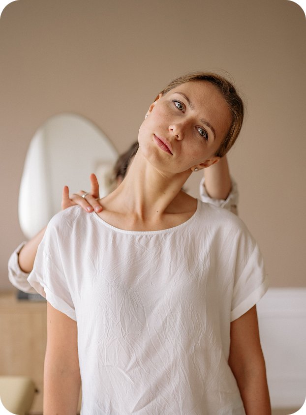 Woman stretching her neck after a whiplash injury